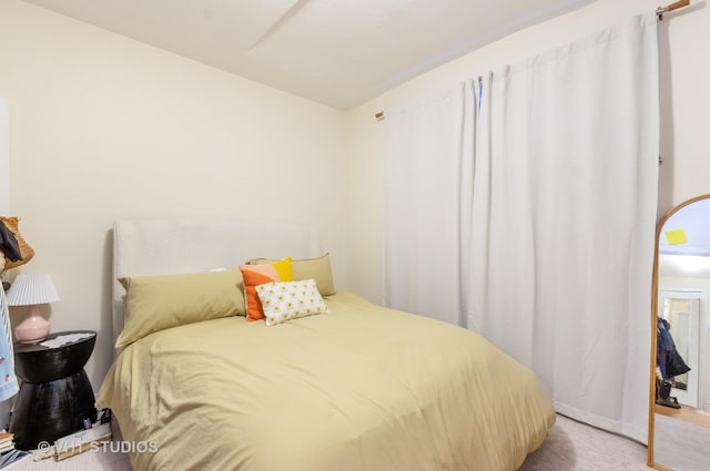 bedroom featuring light colored carpet