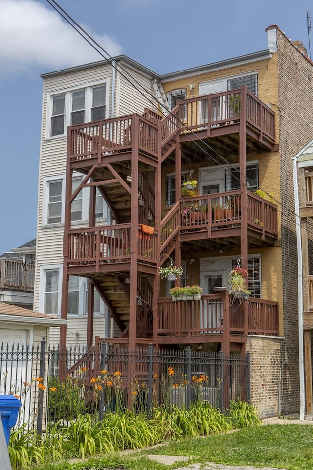 rear view of property featuring fence