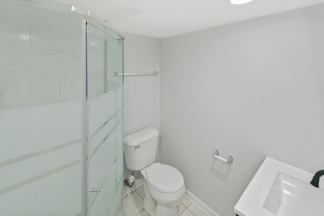 bathroom with tile patterned flooring, vanity, toilet, and a shower with door