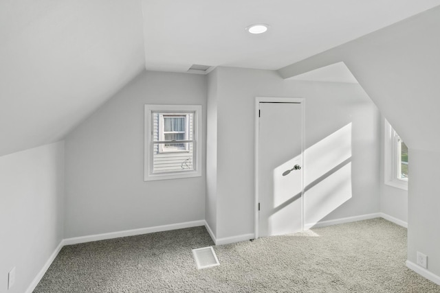 bonus room featuring a wealth of natural light, carpet floors, and vaulted ceiling