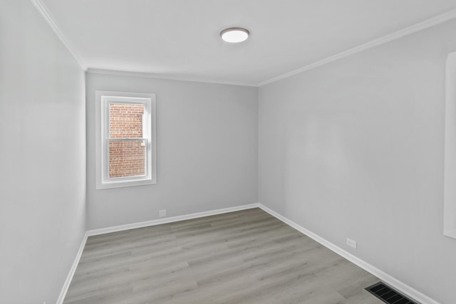 spare room with light hardwood / wood-style flooring and ornamental molding