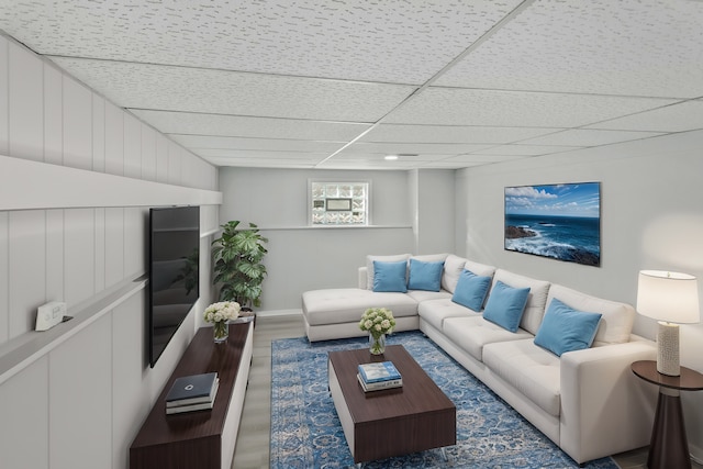 living room featuring a paneled ceiling and wood-type flooring