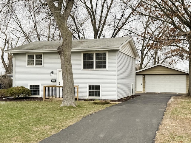 split foyer home featuring an outbuilding, a garage, and a front yard