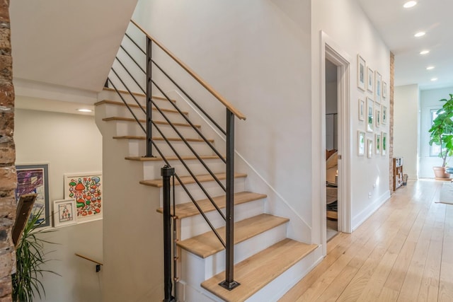 stairs featuring hardwood / wood-style flooring