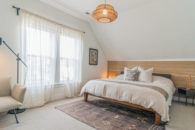 carpeted bedroom featuring lofted ceiling and multiple windows