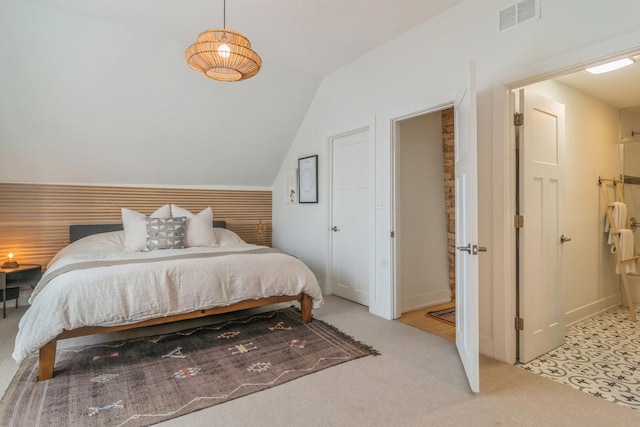 carpeted bedroom featuring vaulted ceiling