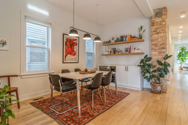 dining area with a wealth of natural light and light hardwood / wood-style floors