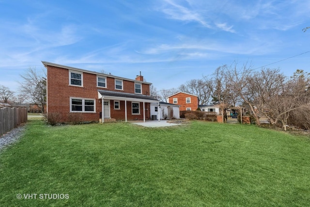 rear view of property with a yard and a patio