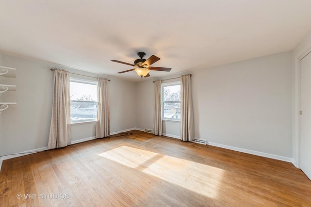 empty room with light hardwood / wood-style floors, plenty of natural light, and ceiling fan