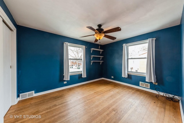 unfurnished bedroom with a closet, ceiling fan, and hardwood / wood-style floors