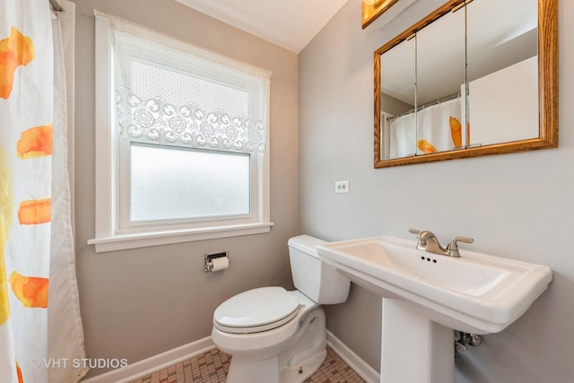 bathroom featuring tile patterned floors and toilet