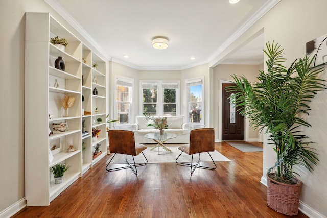 sitting room with hardwood / wood-style flooring and ornamental molding