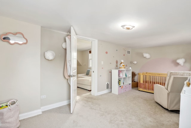 bedroom with light carpet and a nursery area