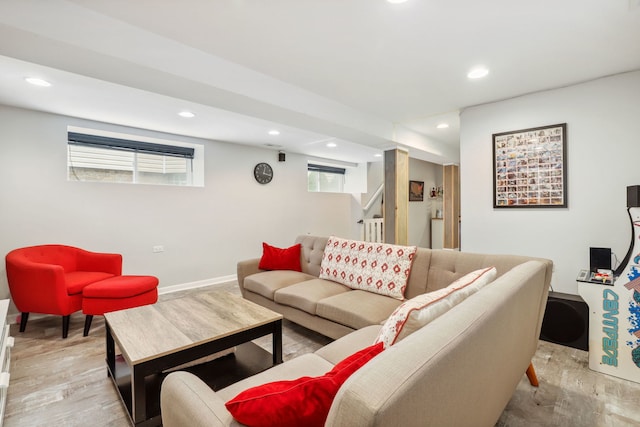 living room with a wealth of natural light and light hardwood / wood-style flooring