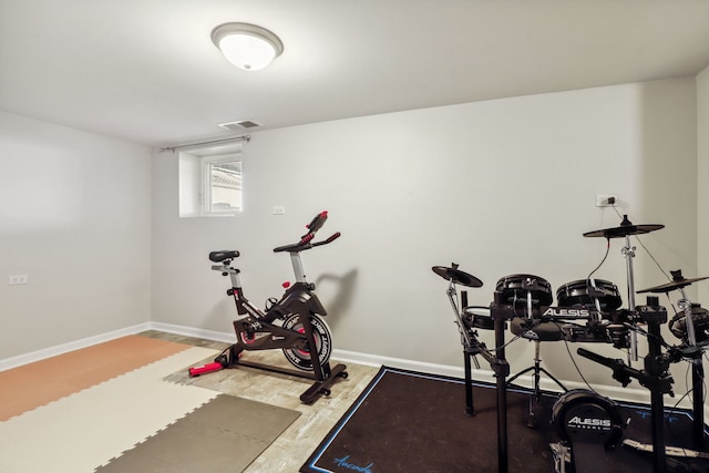 workout room with hardwood / wood-style flooring