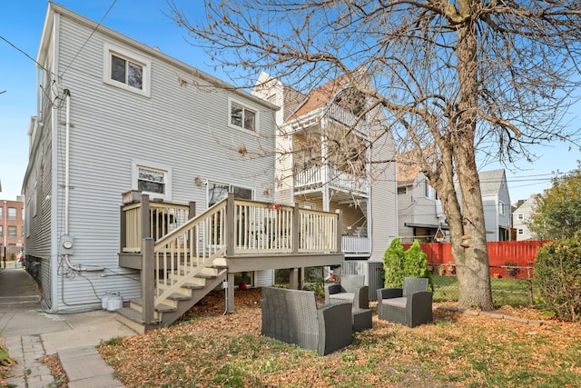 back of property featuring an outdoor hangout area and a deck