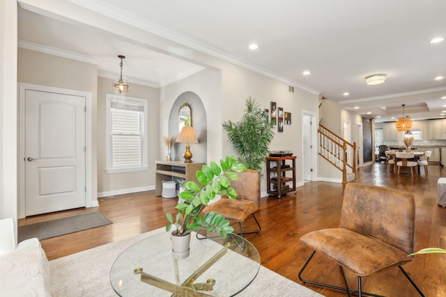 living room featuring dark wood-type flooring and crown molding