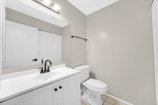 bathroom featuring tile patterned flooring, vanity, and toilet