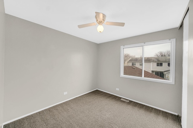 unfurnished room featuring ceiling fan and carpet floors