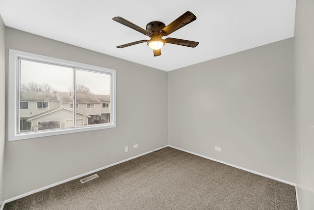 carpeted empty room featuring ceiling fan