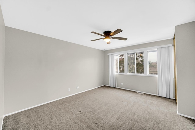 empty room featuring carpet and ceiling fan