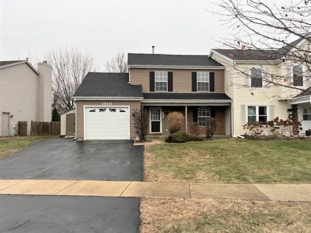 front facade featuring a garage and a front yard