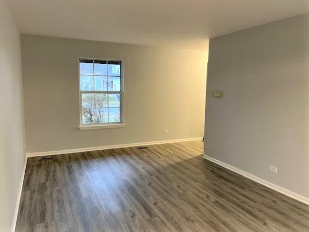 spare room with dark hardwood / wood-style floors