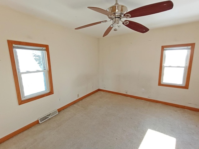 unfurnished room featuring ceiling fan and light carpet