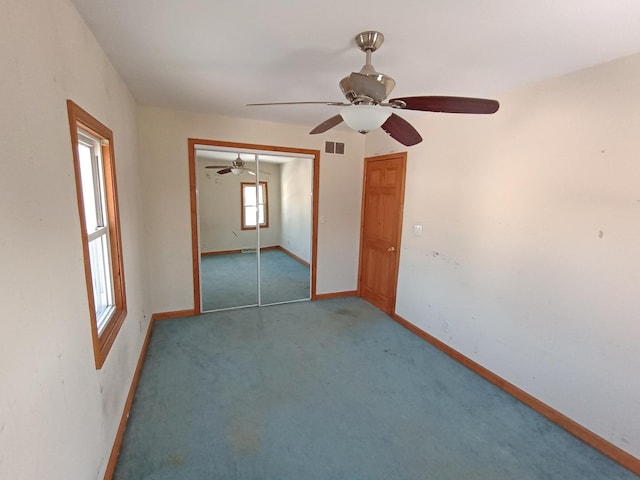 unfurnished room featuring carpet and ceiling fan