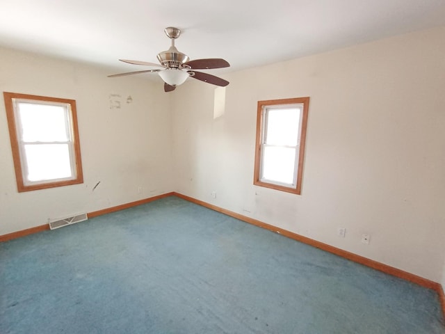 unfurnished room featuring carpet floors, plenty of natural light, and ceiling fan