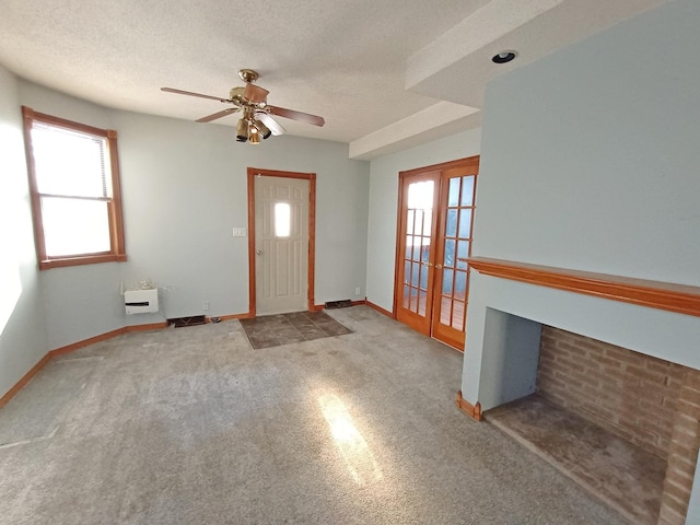 entrance foyer with french doors, a textured ceiling, ceiling fan, and a healthy amount of sunlight