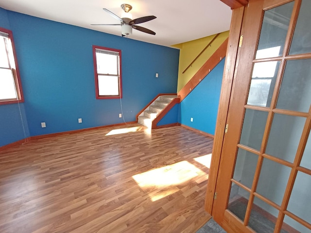 spare room with hardwood / wood-style floors and ceiling fan