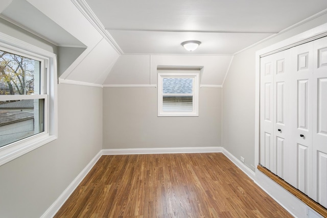 bonus room with hardwood / wood-style floors and lofted ceiling