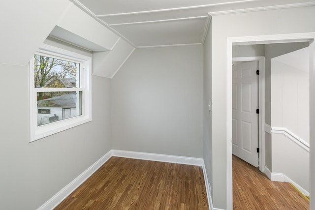 additional living space with lofted ceiling and hardwood / wood-style flooring