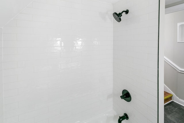 interior details with tiled shower / bath combo