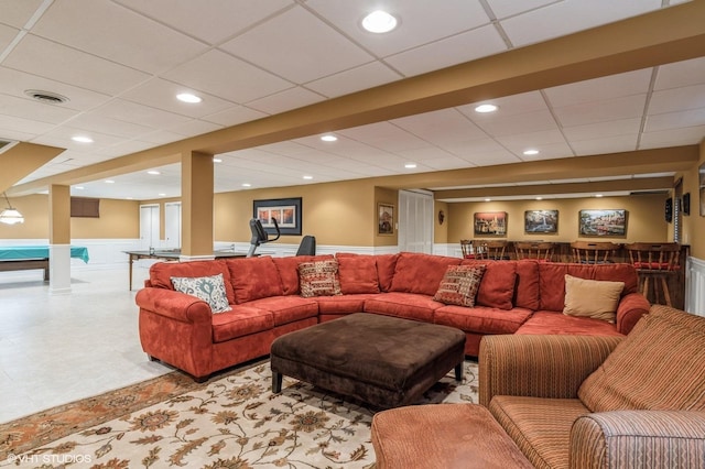 living room featuring a drop ceiling