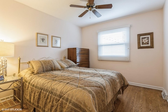 bedroom with dark hardwood / wood-style floors and ceiling fan