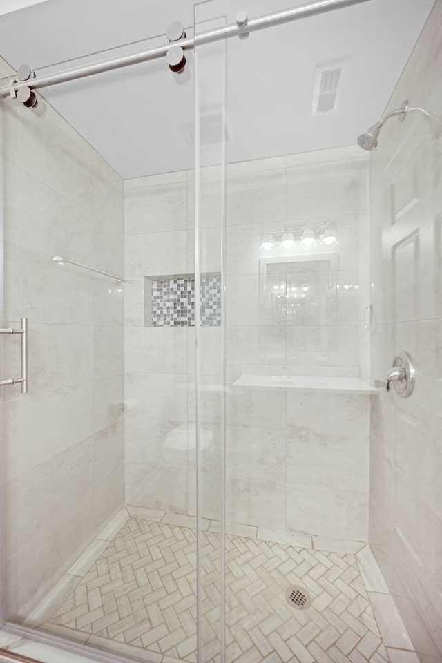 bathroom featuring a shower with shower door