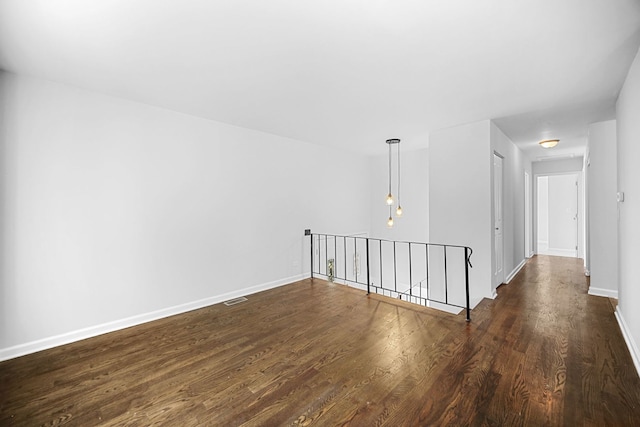 unfurnished room featuring dark wood-type flooring