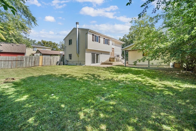 rear view of property featuring a lawn and a patio