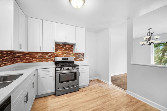 kitchen with a chandelier, white cabinets, and stainless steel appliances