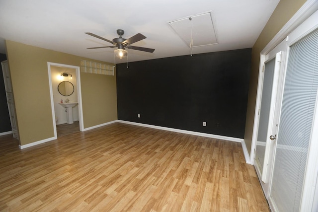 unfurnished bedroom featuring ensuite bathroom, light hardwood / wood-style floors, and ceiling fan