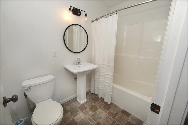 bathroom with shower / bath combination with curtain and toilet