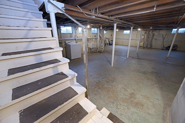 basement featuring sink and washer / dryer