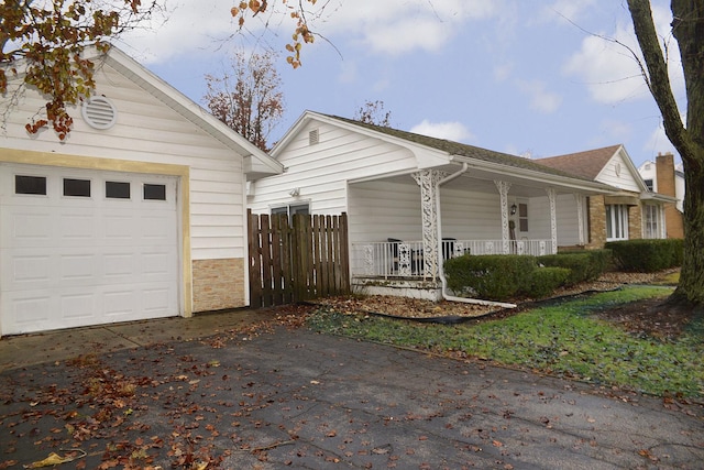 view of front of property with a porch and a garage