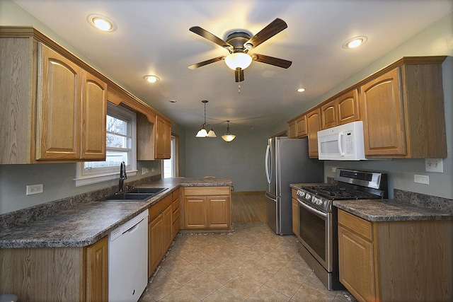 kitchen with white appliances, sink, ceiling fan, light tile patterned floors, and decorative light fixtures