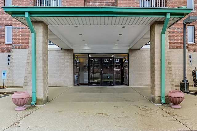 view of exterior entry with french doors and a carport