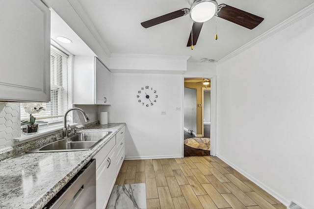 kitchen with white cabinets, crown molding, sink, and light hardwood / wood-style flooring