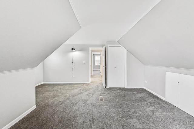 bonus room with carpet flooring and lofted ceiling