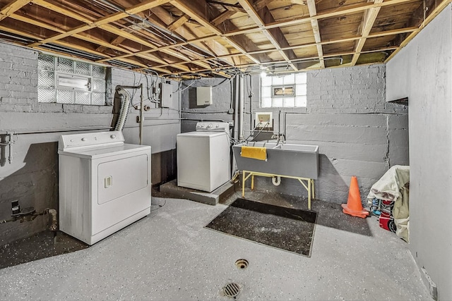 laundry area with sink and washing machine and clothes dryer